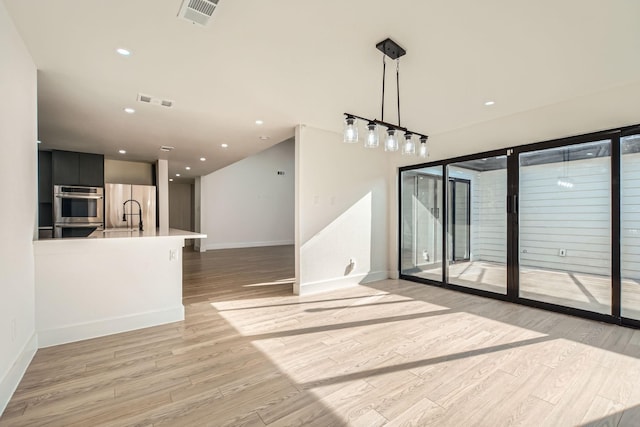 16212 Spring Creek Rd, Dallas, TX 75248 - unfurnished living room with baseboards, light wood finished floors, and recessed lighting