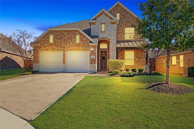 1409 Rose Bud Ct, Little Elm, TX 75068 - view of front of house with an attached garage, brick siding, concrete driveway, and a lawn