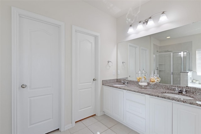 1409 Rose Bud Ct, Little Elm, TX 75068 - bathroom with a stall shower, double vanity, and tile patterned floors
