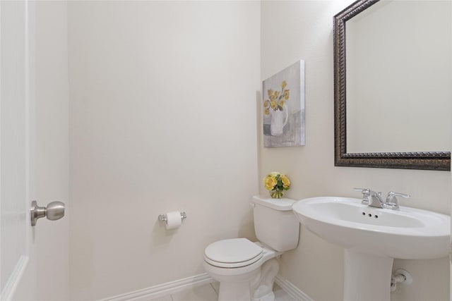 1409 Rose Bud Ct, Little Elm, TX 75068 - bathroom with toilet, baseboards, tile patterned flooring, and a sink