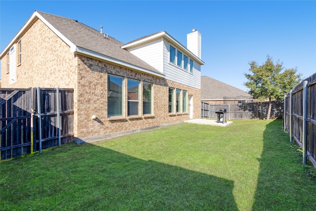 1409 Rose Bud Ct, Little Elm, TX 75068 - back of house featuring brick siding, a chimney, a shingled roof, and a patio area