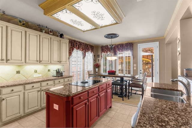 7904 Linksview Dr, Mckinney, TX 75072 - kitchen featuring a sink, black electric stovetop, cream cabinetry, ornamental molding, and light tile patterned flooring