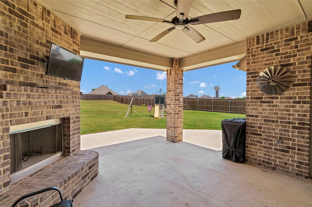 110 Oak View Dr, Godley, TX 76044 - view of patio featuring an outdoor brick fireplace, a playground, and a ceiling fan