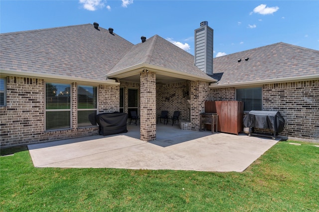 110 Oak View Dr, Godley, TX 76044 - rear view of property featuring brick siding, a patio area, and a lawn