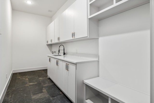 3940 N Cresthaven, Dallas, TX 75209 - washroom with a sink, baseboards, dark stone finish floors, and recessed lighting