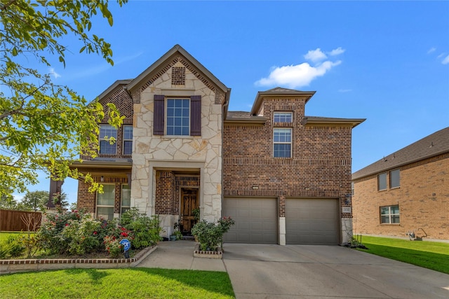 1030 Speargrass Ln, Prosper, TX 75078 - view of front of home with stone siding, brick siding, concrete driveway, and an attached garage