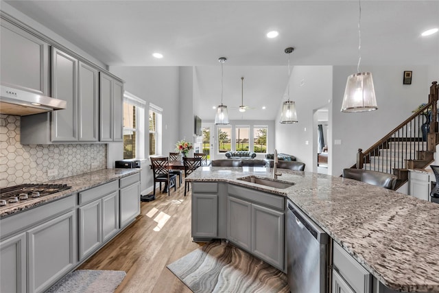 1030 Speargrass Ln, Prosper, TX 75078 - kitchen with gray cabinetry, stainless steel appliances, ceiling fan, plenty of natural light, and recessed lighting