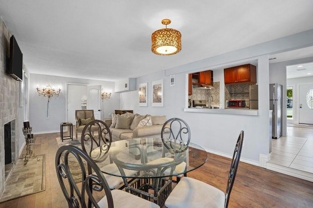 4504 Hodgkins Rd, Lake Worth, TX 76135 - dining space with wood finished floors, a fireplace, and baseboards