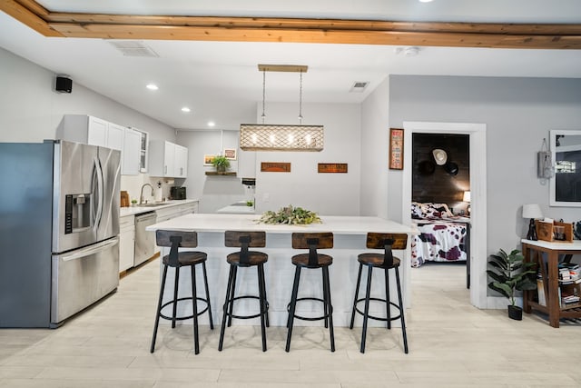1430 Rs County Road 1605, Point, TX 75472 - kitchen featuring appliances with stainless steel finishes, light countertops, recessed lighting, a kitchen breakfast bar, and white cabinetry