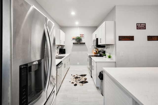 1430 Rs County Road 1605, Point, TX 75472 - kitchen with appliances with stainless steel finishes, light countertops, light wood-type flooring, white cabinetry, and recessed lighting