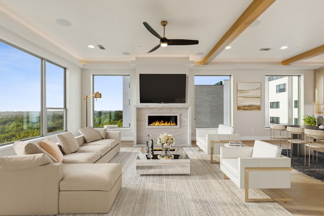4929 Blaynes Vw, The Colony, TX 75056 - living area featuring a high end fireplace, light wood-style floors, ceiling fan, beamed ceiling, and baseboards