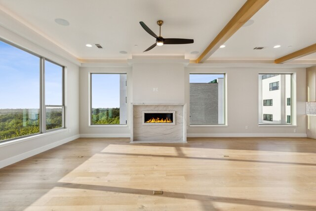 4929 Blaynes Vw, The Colony, TX 75056 - unfurnished living room with ceiling fan, a premium fireplace, baseboards, wood finished floors, and beam ceiling