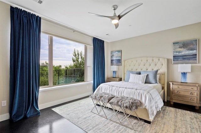 13001 Hutton Dr Unit 31, Farmers Branch, TX 75234 - bedroom featuring baseboards, ceiling fan, and finished concrete flooring