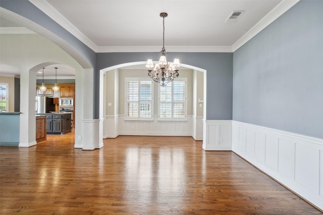 8304 Old Hickory Ln, Mckinney, TX 75072 - unfurnished dining area featuring plenty of natural light, dark wood-style flooring, a chandelier, ornamental molding, and arched walkways