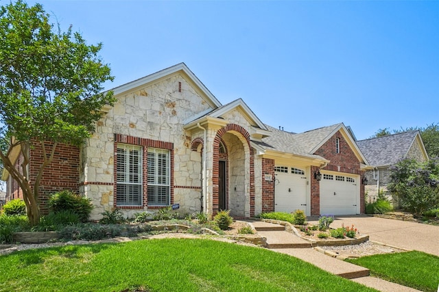 8304 Old Hickory Ln, Mckinney, TX 75072 - view of front facade with stone siding, an attached garage, concrete driveway, and a front yard