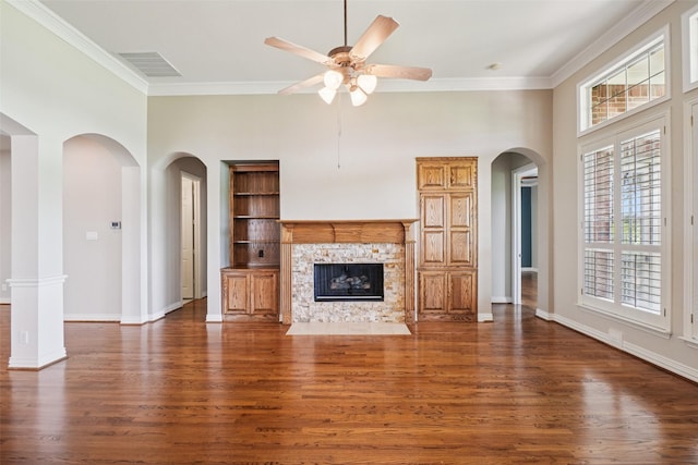 8304 Old Hickory Ln, Mckinney, TX 75072 - unfurnished living room with ceiling fan, ornamental molding, wood finished floors, arched walkways, and built in features