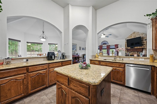 14708 Myrtle Beach Ln, Frisco, TX 75035 - kitchen featuring dishwasher, a sink, vaulted ceiling, a ceiling fan, and light stone countertops
