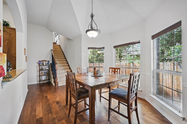 14708 Myrtle Beach Ln, Frisco, TX 75035 - dining space featuring vaulted ceiling, dark wood-type flooring, stairway, and baseboards