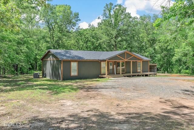 4382 Circle Square Dr, Mooringsport, LA 71060 - view of front of property featuring central AC unit, driveway, a view of trees, and roof with shingles