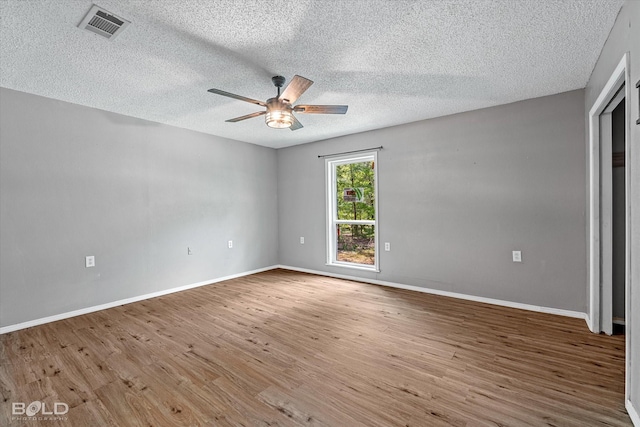 4382 Circle Square Dr, Mooringsport, LA 71060 - unfurnished room with a ceiling fan, wood finished floors, a textured ceiling, and baseboards