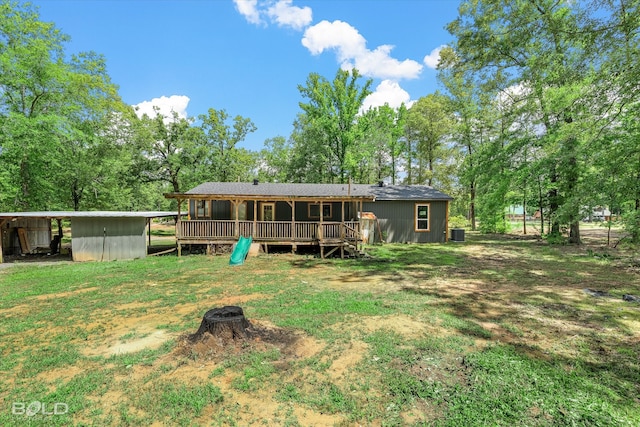 4382 Circle Square Dr, Mooringsport, LA 71060 - rear view of house featuring a deck, central AC unit, view of scattered trees, and a lawn