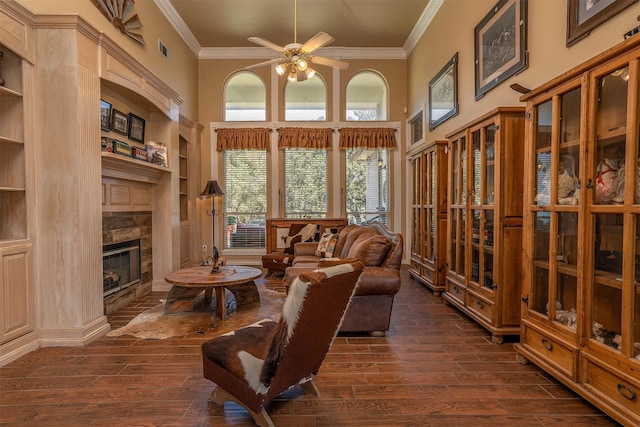 1701 W Lake Shore Dr, Alvarado, TX 76009 - living room featuring ornamental molding, dark wood finished floors, a high ceiling, a glass covered fireplace, and built in features