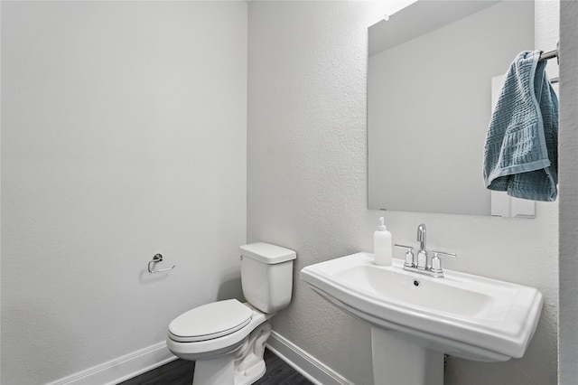 6133 Poolside Way, Royse City, TX 75189 - half bath with wood finished floors, toilet, baseboards, and a sink