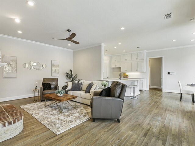 4033 Oakhaven Dr, Plano, TX 75093 - living room featuring ornamental molding, light wood-style flooring, baseboards, ceiling fan, and recessed lighting