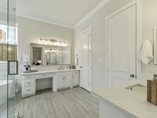 4033 Oakhaven Dr, Plano, TX 75093 - bathroom featuring two vanities, a freestanding tub, and ornamental molding