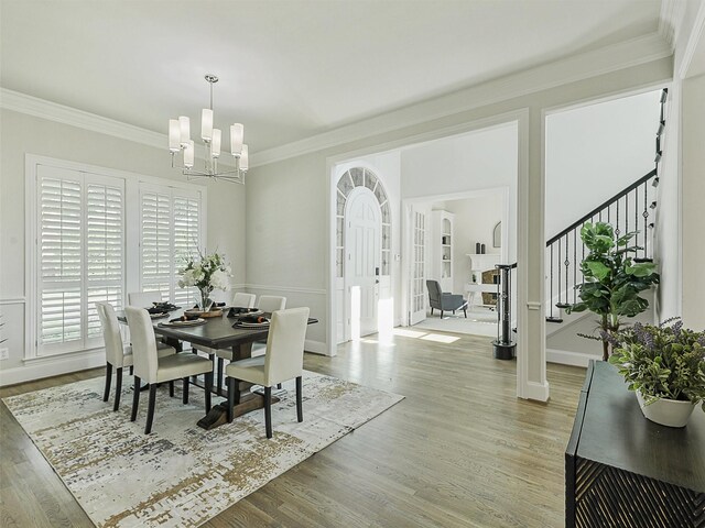 4033 Oakhaven Dr, Plano, TX 75093 - dining area featuring a chandelier, light wood-style floors, ornamental molding, stairway, and baseboards