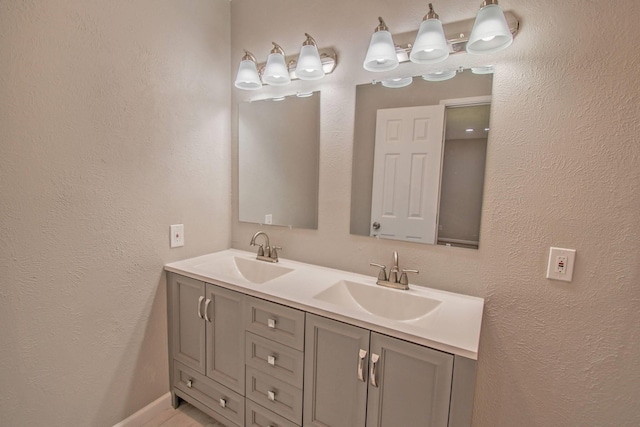 3825 Hackberry Ln, Bedford, TX 76021 - bathroom featuring double vanity and a textured wall