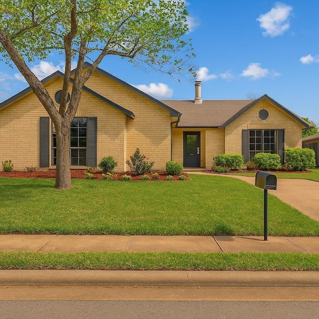 3825 Hackberry Ln, Bedford, TX 76021 - view of front facade featuring a front yard and brick siding