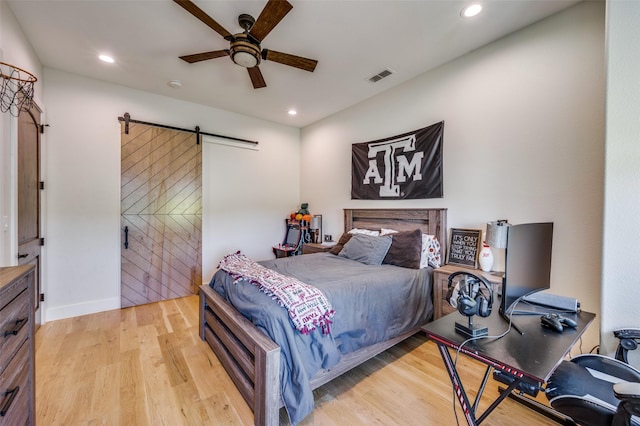 221 Cattle Trl, Tioga, TX 76271 - bedroom featuring a barn door, light wood finished floors, recessed lighting, a ceiling fan, and baseboards