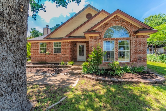 809 W Ball St, Weatherford, TX 76086 - view of front of home with brick siding and a chimney