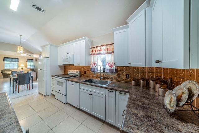 809 W Ball St, Weatherford, TX 76086 - kitchen featuring a sink, white appliances, tasteful backsplash, vaulted ceiling, and light tile patterned flooring