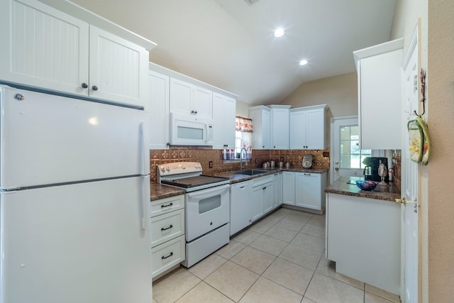 809 W Ball St, Weatherford, TX 76086 - kitchen featuring white appliances, tasteful backsplash, dark countertops, light tile patterned floors, and vaulted ceiling