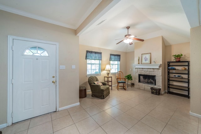 809 W Ball St, Weatherford, TX 76086 - foyer featuring a ceiling fan, a stone fireplace, baseboards, light tile patterned floors, and vaulted ceiling