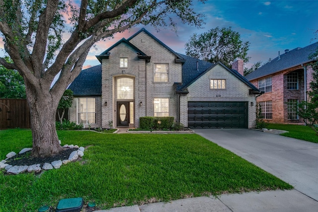 901 Sugarberry Ln, Flower Mound, TX 75028 - french country inspired facade featuring brick siding, an attached garage, and driveway