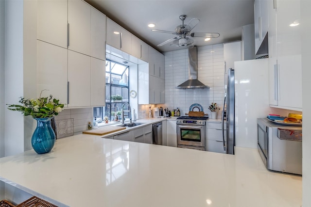 3548 Granada Ave, University Park, TX 75205 - kitchen featuring wall chimney range hood, appliances with stainless steel finishes, a sink, decorative backsplash, and light countertops