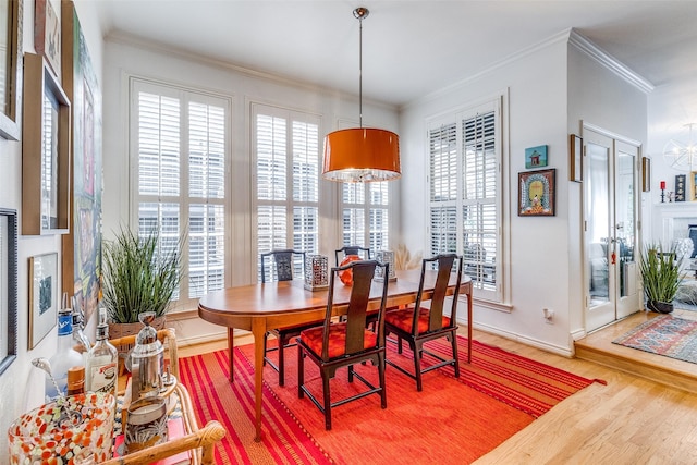 3548 Granada Ave, University Park, TX 75205 - dining room with a fireplace, healthy amount of natural light, light wood-style flooring, crown molding, and baseboards