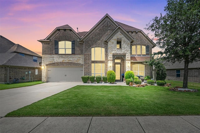 505 Kappa Way, Mckinney, TX 75071 - french country home featuring driveway, stone siding, a front lawn, an attached garage, and brick siding
