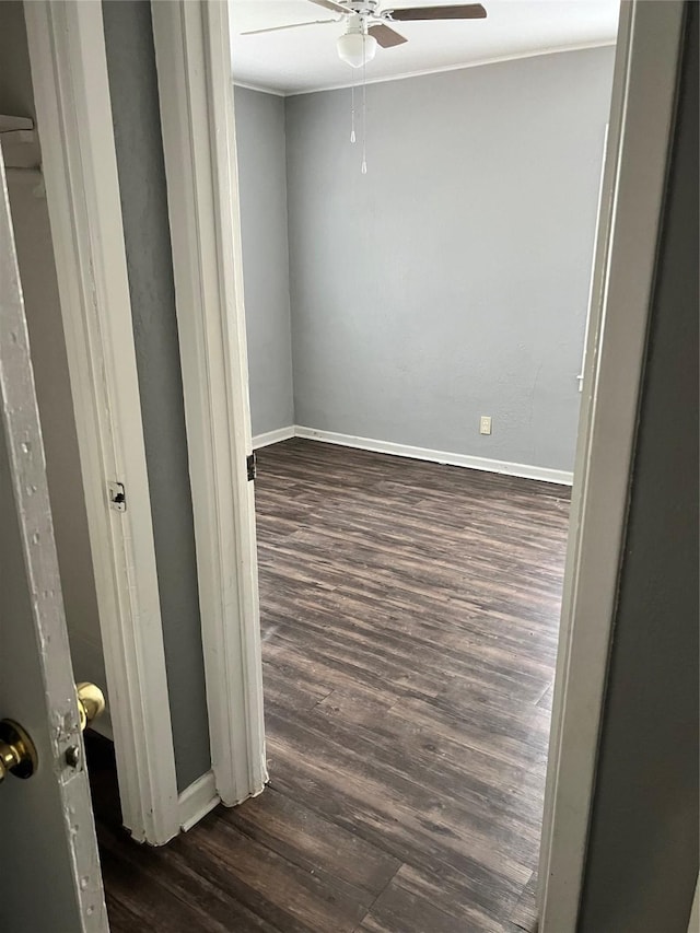 2907 W Collin St, Corsicana, TX 75110 - empty room featuring dark wood finished floors, ceiling fan, and baseboards