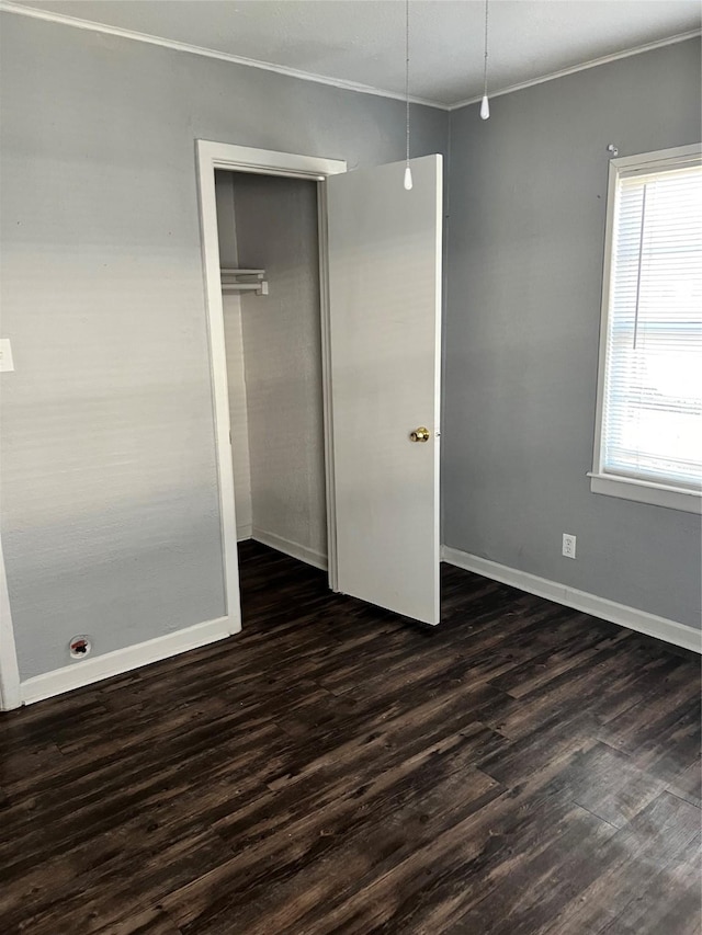 2907 W Collin St, Corsicana, TX 75110 - unfurnished bedroom with crown molding, dark wood finished floors, a closet, and baseboards
