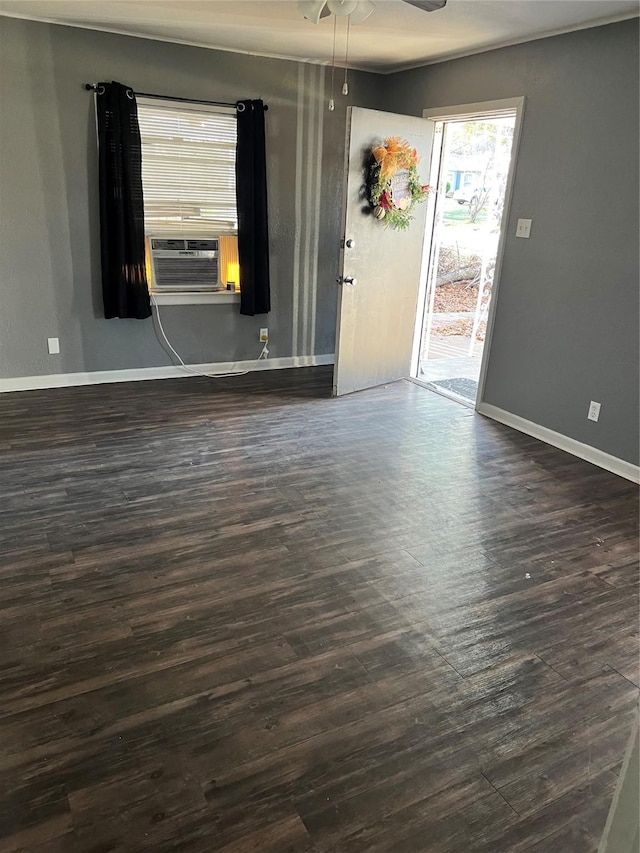 2907 W Collin St, Corsicana, TX 75110 - unfurnished room featuring cooling unit, dark wood-style flooring, baseboards, and a ceiling fan