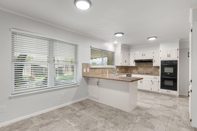 4814 Rhea Rd, Wichita Falls, TX 76308 - kitchen featuring black appliances, a sink, crown molding, under cabinet range hood, and white cabinetry