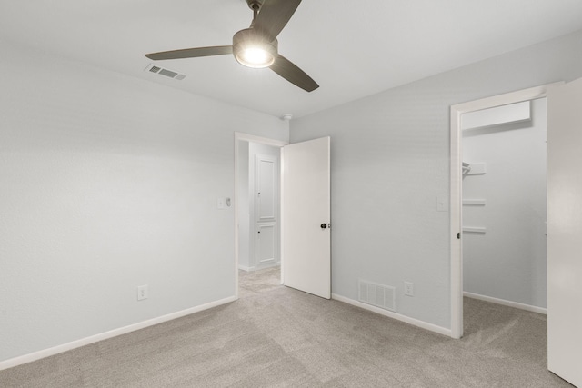 4814 Rhea Rd, Wichita Falls, TX 76308 - unfurnished bedroom featuring carpet floors, a walk in closet, a ceiling fan, and baseboards
