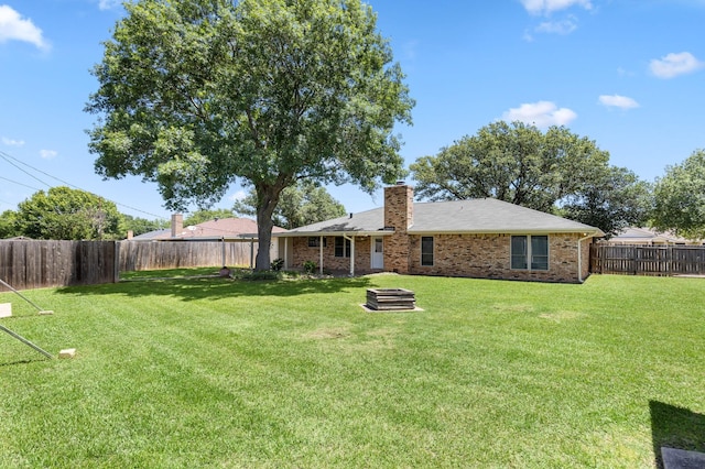 4814 Rhea Rd, Wichita Falls, TX 76308 - back of house featuring a chimney and brick siding