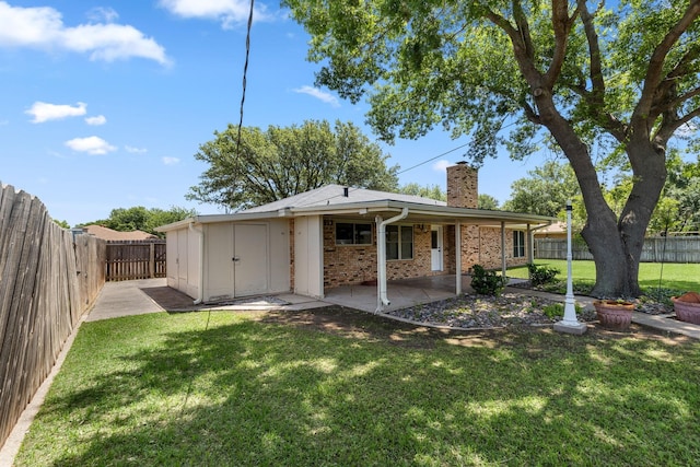 4814 Rhea Rd, Wichita Falls, TX 76308 - back of property with a chimney, a patio, and brick siding