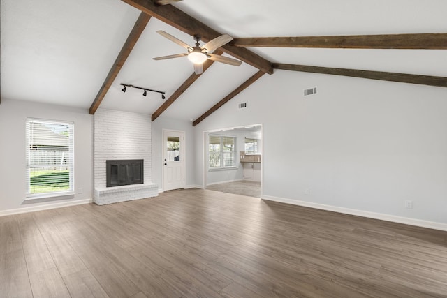 4814 Rhea Rd, Wichita Falls, TX 76308 - unfurnished living room with a fireplace, a ceiling fan, beam ceiling, wood finished floors, and baseboards