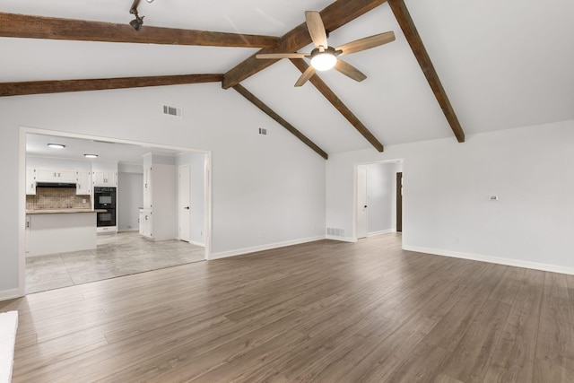 4814 Rhea Rd, Wichita Falls, TX 76308 - unfurnished living room with ceiling fan, beam ceiling, light wood finished floors, baseboards, and high vaulted ceiling